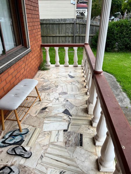 The previous owners had built much of the home themselves, resulting in a mix of styles. It had remained untouched for decades and was in need of a full renovation, both inside and out. When undertaking their renovation, however, Benjamin and E wanted to retain many of the original details—including the paving on the front porch and the ornate balustrade and columns.