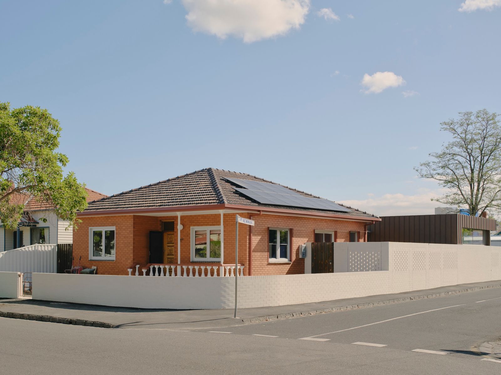 The renovated home retains the existing charm of original, but has been sensitively updated for contemporary living. The front of the home remains largely the same, while the rear—which contains the living, kitchen and dining areas, alongside a separate studio, has been rebuilt in a striking, modern style. The new white brick wall that runs around the property is lower at the front to encourage interaction with the street and neighbours.