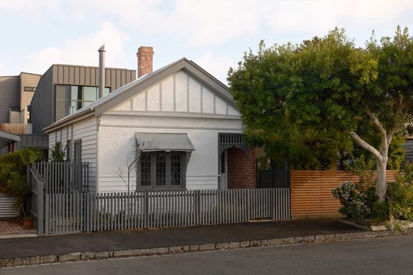 The old and new volumes are clearly distinct in style. Visual connection is created by the the vertical rhythm of the new cladding echoing the timber work on the original gable roof, and the neutral color palette.