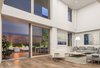 A one-of-a-kind new duplex residence in Candela Lofts has hit the market with an unrivaled offering of living and entertaining space, including a sprawling 870 square-foot outdoor terrace complete with an outdoor Lynx kitchen system, ipe decking and fire pit. The two-story, four-bedroom plus office, 3 ½-bath residence is one of only two homes remaining at the seven-story Candela Lofts building. Photo of Candela Lofts modern home
