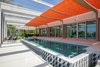 Modern home with Outdoor, Swimming Pools, Tubs, Shower, Concrete Patio, Porch, Deck, Large Patio, Porch, Deck, Concrete Pools, Tubs, Shower, and Large Pools, Tubs, Shower. Pool cage with retractable shades in Paul Rudolph's signature orange. Photo of The Schechter House