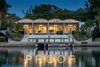 Modern home with Windows, Sliding Window Type, and Metal. Nighttime water view of the Sanderling Beach Club inspired roofline. Photo 2 of The Schechter House