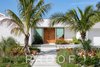 Modern home with Doors, Wood, Exterior, and Swing Door Type. A chill Florida-friendly welcome. Landscaping includes heat resistant plants like ground orchids, cabbage palms, bromeliads, gumbo limbo trees, and sea grapes. Photo 5 of The Schechter House