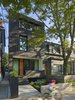 Modern home with Exterior, Wood Siding Material, House Building Type, and Shingles Roof Material. The all-black exterior cladding creates a quiet pause in the streetscape. By day, it acts as an abstract canvas for shadow play from the boulevard trees. By night, it has the quality of an austere lantern. Photo 3 of Bellwoods Lodge