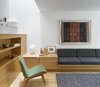 Modern home with Living Room, Medium Hardwood Floor, and Chair. The library area with seating under the light well, and soaring views up through all three levels. Photo 11 of Bellwoods Lodge