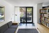 Modern home with Living Room. The library area features built-in seating and a walk-out to the front terrace. A floating bookcase visually separates the second lower level entrance, without restricting verbal greetings to or from the main living areas. Photo 12 of Bellwoods Lodge