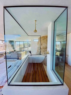 The Juniper room's centerpiece boulder sits just behind the open shower. "We built this little elevated bathroom that allows you to get the full effect of the views while in the shower," notes Rich.