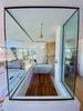Modern home with Bath Room and Open Shower. The Juniper room's centerpiece boulder sits just behind the open shower. "We built this little elevated bathroom that allows you to get the full effect of the views while in the shower," notes Rich. Photo 7 of Whisper Rock Ranch