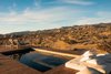 Modern home with Outdoor, Boulders, Back Yard, Wood Patio, Porch, Deck, Shrubs, Desert, Swimming Pools, Tubs, Shower, and Landscape Lighting. "Since we're completely off grid we operate off of hauled water, so we have three 1,800 gallon tanks that get filled up every other week. But for those same reasons, people off the grid don't really have pools because they're hard to maintain, but we did it anyway." Photo 4 of Whisper Rock Ranch