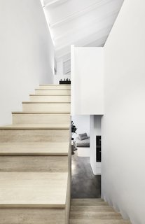 A new "secret" staircase now lies opposite the entrance, leading to an attic above the "white box" form. It is accessed via an operable bookcase door.