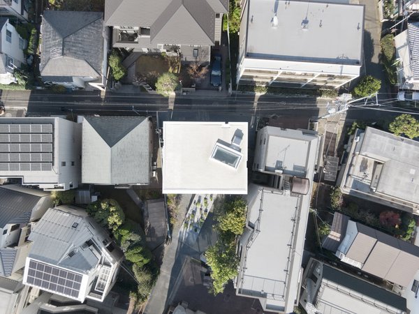 An aerial view shows the neighborhood’s density and the relationship of the house with the lane in front of it.