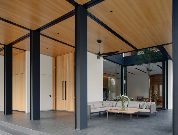 The house's structural system is most apparent at the first storey sheltered, outdoor parts that are covered by an expansive timber ceiling.