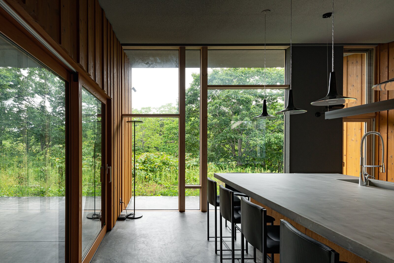 Like the other common spaces, the kitchen extends to a terrace on the building's east elevation. 