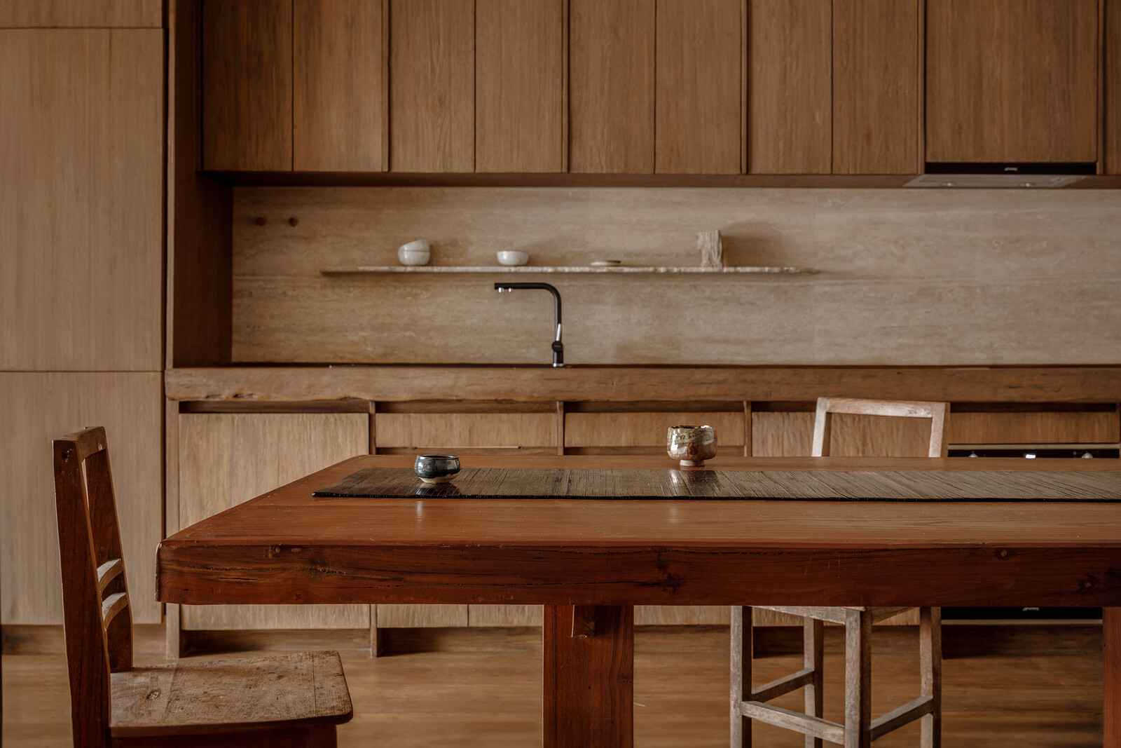 Antique teak cabinetry in the kitchen and dining area brings a warm atmosphere. 