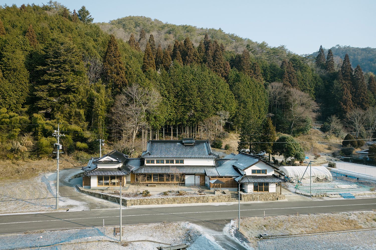 Architect Reiichi Ikeda renovated this house in Jinseki, Japan, in two phases, starting with the main house (center) and annex (left).