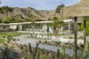 Modern home with Outdoor, Trees, Gardens, Walkways, Front Yard, and Hardscapes. "The client’s goals were to create an open and light-filled home that maximized views of the Coachella Valley below and the Santa Rosa mountains to the south and west," says designer Stuart Silk Architects. Thunderbird Heights Residence enjoys a fluid connection between the primary indoor rooms and the outdoor terraces both for entertaining and casual outdoor living. Photo 13 of Thunderbird Heights Residence