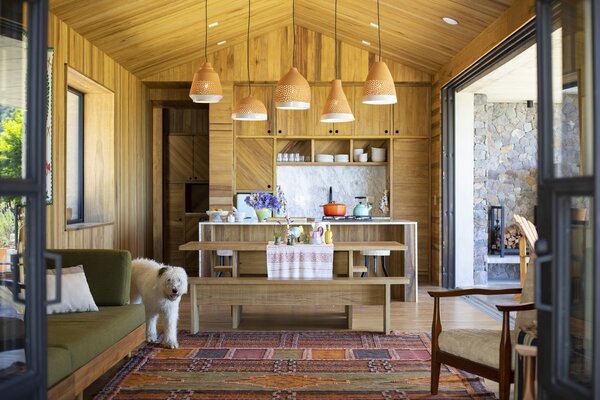 Matching the grain and texture of the kitchen to the rest of the cladding in the house creates a seamless look and adds coziness and warmth to an otherwise-open space.
