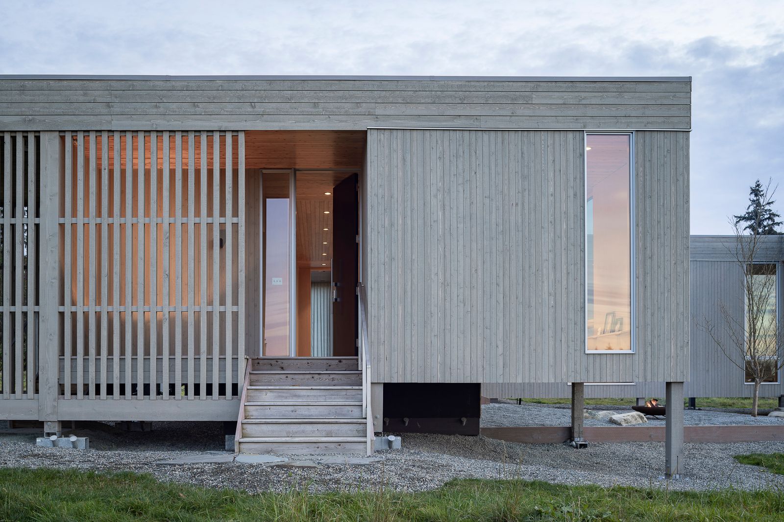 The cabin's entrance is screened by tight knot cedar members, and a narrow vertical window gives a peek inside the cabin's meditation room.