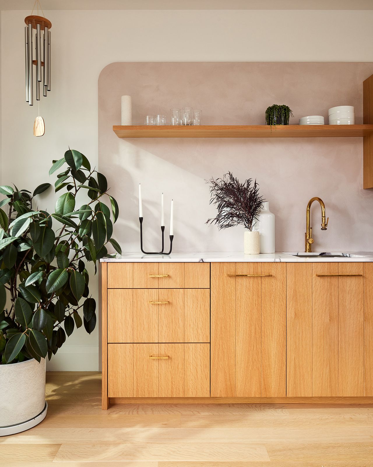 The countertop in the kitchenette is a lilac marble from ABC Stone, and the cabinetry is custom oak. The faucet is from Waterstone.