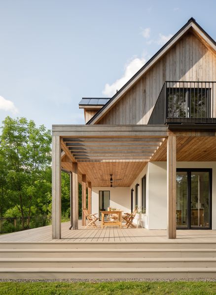 The roof has the added benefit of providing cover for an outdoor dining space, which connects to the larger wraparound deck.