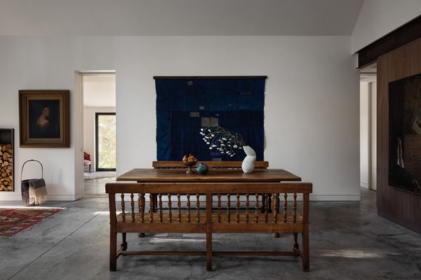 An antique French farm table anchors the dining area-- it is the same table the homeowner had in her parents' house growing up. The clients had an affinity for Japanese art, including the earth 20th century Boro futon cover from Japan hanging behind the dining table, so they immediately took to the kintsugi floor idea. The table vase is by Hana Tajima, who together with Colin Moore Bradley of Maru Projects completed the kintsugi floors.
