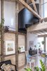 Modern home with Living Room, Pendant Lighting, Light Hardwood Floor, and Chair. Some of the original roof trusses, removed during the renovation have been reused to create characterful details in the living areas. Photo 6 of Arklow Villa III