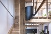 Modern home with Staircase, Wood Tread, Wood Railing, and Metal Railing. The staircase leading up to the main bedroom, bathroom and snug starts as a simple wooden stair, but becomes a steel spiral towards the top. Photo 7 of Arklow Villa III