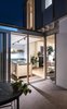 The kitchen boasts custom-designed units topped with a vibrant green marble. A brick floor extends out into the new courtyard at the rear Photo 11 of Arklow Villa III modern home