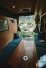 Modern home with Living Room, Ceiling Lighting, Bench, and Dark Hardwood Floor. Back doors open and fold away for unparalleled views into the outdoors. Both sets of bench seats have access to large storage areas. Photo 2 of The Pennybago