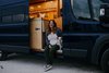 Modern home with Kitchen, Drop In Sink, Refrigerator, Wood Counter, Wood Cabinet, Dark Hardwood Floor, Ceiling Lighting, and Wood Backsplashe. Home owner, Laurén Ettinger and her pup Penny live and travel full time in their tiny home on wheels. Photo 5 of The Pennybago