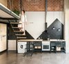 Modern home with Kitchen, Wood Counter, Metal Cabinet, Concrete Floor, Open Cabinet, Vessel Sink, and Pendant Lighting. The public area of the apartment, which includes the kitchen, has an open floor plan. The floor is a simple concrete solution used in garages which, combined with brass profiles to prevent cracks, unifies the whole floor of the apartment. Photo 2 of #UPHouse