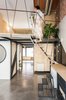 Modern home with Staircase, Metal Tread, Wood Tread, and Metal Railing. The main stair to the mezzanine level is accessed by set of steps that can be moved out of the way when not in use. Photo 4 of #UPHouse