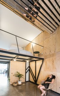 Natural light floods the studio through a large window and is reflected into the mezzanine level via the mirrored "vault."