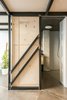 Modern home with Doors, Sliding Door Type, Interior, and Wood. The new mezzanine is supported by six exposed steel frames that stabilize and distribute the weight. This approach negated the need for structural columns in the open floor space. Photo 8 of #UPHouse
