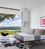 Modern home with Bedroom, Ceiling Lighting, Bed, Rug Floor, Concrete Floor, Chair, and Pendant Lighting. Lago Vista by Dick Clark + Associates Photo 3 of Lago Vista