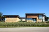 Modern home with Exterior, Hipped RoofLine, Stucco Siding Material, Metal Roof Material, Wood Siding Material, Gable RoofLine, House Building Type, and Stone Siding Material. Lago Vista by Dick Clark + Associates Photo of Lago Vista