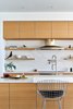 Modern home with Kitchen, Stone Counter, Ceiling Lighting, Range Hood, Undermount Sink, Range, Recessed Lighting, Stone Slab Backsplashe, and Wood Cabinet. Lago Vista by Dick Clark + Associates Photo 10 of Lago Vista