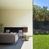 Modern home with Outdoor, Shrubs, Tile Patio, Porch, Deck, Small Patio, Porch, Deck, Back Yard, Horizontal Fences, Wall, and Grass. 007 House by Dick Clark + Associates Photo 3 of 007 House