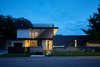 Modern home with Exterior, House Building Type, Flat RoofLine, Metal Roof Material, Stucco Siding Material, Hipped RoofLine, Metal Siding Material, and Wood Siding Material. 007 House by Dick Clark + Associates Photo 8 of 007 House