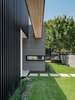 Modern home with Exterior, House Building Type, Stucco Siding Material, Metal Siding Material, Flat RoofLine, Metal Roof Material, and Wood Siding Material. 007 House by Dick Clark + Associates Photo 10 of 007 House