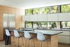 Modern home with Kitchen, Stone Counter, White Cabinet, Refrigerator, Wood Cabinet, Light Hardwood Floor, and Cooktops. Windsor Residence by Dick Clark + Associates Photo 9 of Windsor Residence
