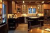 Modern home with Kitchen, Granite Counter, Cooktops, Wood Cabinet, Drop In Sink, Ceiling Lighting, Light Hardwood Floor, and Refrigerator. Kitchen in AQ-1. The sink / window opens onto the west side Garden Room Photo 4 of Aquarius 1 Mass Timber Geo-Solar home by Enertia®