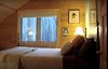 Modern home with Bedroom, Bed, Table Lighting, and Carpet Floor. Upstairs Bedroom 2 in the Aquarius 1 by Enertia® Pre-fab Photo 7 of Aquarius 1 Mass Timber Geo-Solar home by Enertia®