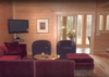 Modern home with Living Room, Sectional, Light Hardwood Floor, and Ceiling Lighting. Living Room to Sunspace. In the fall and spring, the glass slider can be left open Photo 8 of Aquarius 1 Mass Timber Geo-Solar home by Enertia®