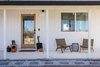 Modern home with Exterior, House Building Type, Shingles Roof Material, Cabin Building Type, and Wood Siding Material. After: Front Facade Photo of Mojave Mesa House