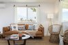 Modern home with Living Room, Coffee Tables, Chair, End Tables, Porcelain Tile Floor, Sofa, and Floor Lighting. After: The Living Room Photo 7 of Mojave Mesa House