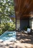 Modern home with Outdoor, Front Yard, Swimming Pools, Tubs, Shower, Shrubs, Garden, Gardens, Small Pools, Tubs, Shower, Concrete Patio, Porch, Deck, Grass, Trees, Wood Patio, Porch, Deck, Metal Patio, Porch, Deck, Side Yard, Decking Patio, Porch, Deck, Stone Patio, Porch, Deck, Landscape Lighting, and Concrete Pools, Tubs, Shower. designed by Estúdio Minke Photo 4 of Casa da Pedra (The stone house)