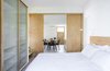 Modern home with Bedroom, Bed, Porcelain Tile Floor, Ceiling Lighting, Floor Lighting, Wardrobe, Light Hardwood Floor, Wall Lighting, Dresser, and Bench. designed by Estúdio Minke Photo 11 of Casa da Pedra (The stone house)