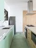 Modern home with Kitchen, Quartzite Counter, Ceramic Tile Floor, Refrigerator, Wood Cabinet, Ceiling Lighting, Wall Lighting, Ceramic Tile Backsplashe, Porcelain Tile Floor, Cooktops, and Colorful Cabinet. designed by Estúdio Minke Photo 12 of Casa da Pedra (The stone house)