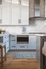 Modern home with Kitchen, Microwave, White Cabinet, Range, Range Hood, Medium Hardwood Floor, and Mosaic Tile Backsplashe. Athens Kitchen Range Wall Photo 4 of Athens Home